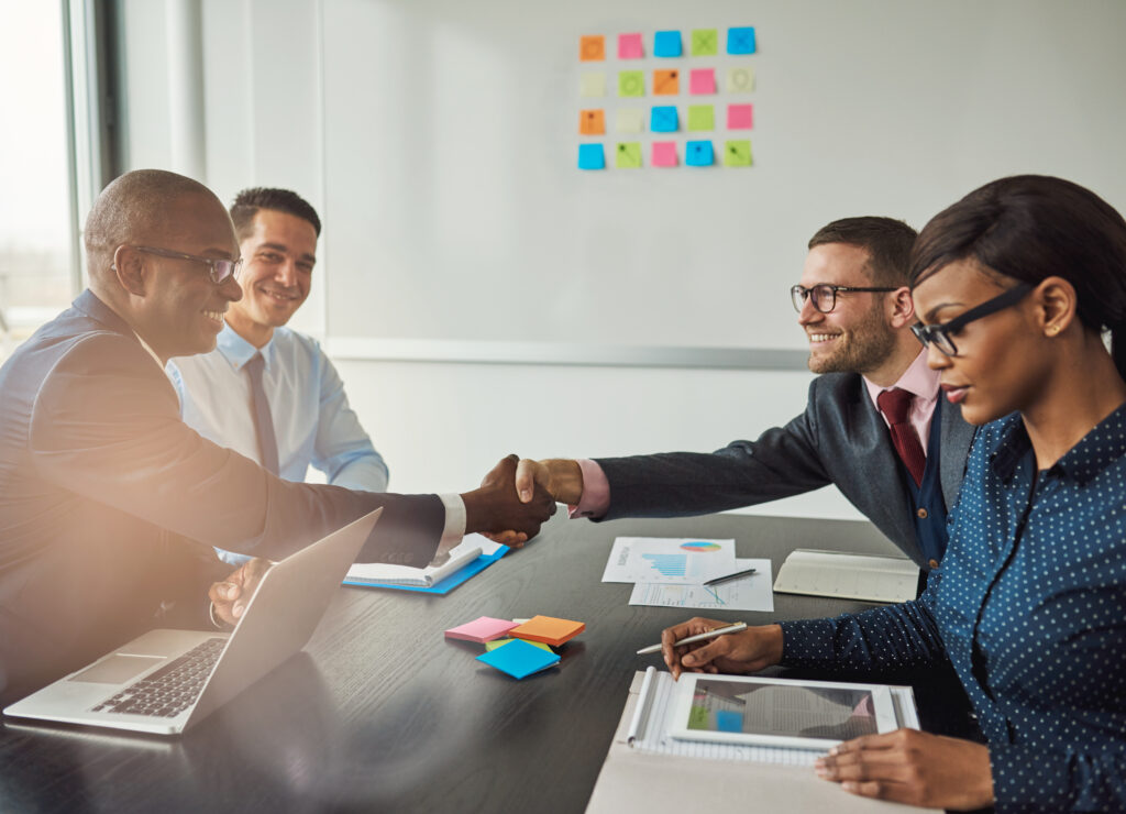Two customer acquisition strategists shaking hands