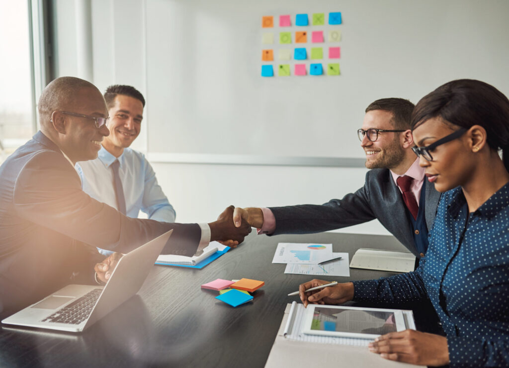 Two customer acquisition strategists shaking hands